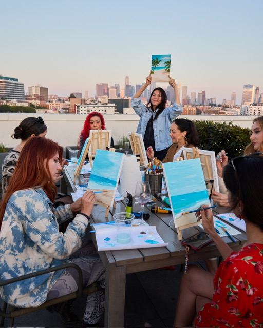 Zuzi Szokeova teaching and demonstrating painting techniques at a rooftop class in Los Angeles